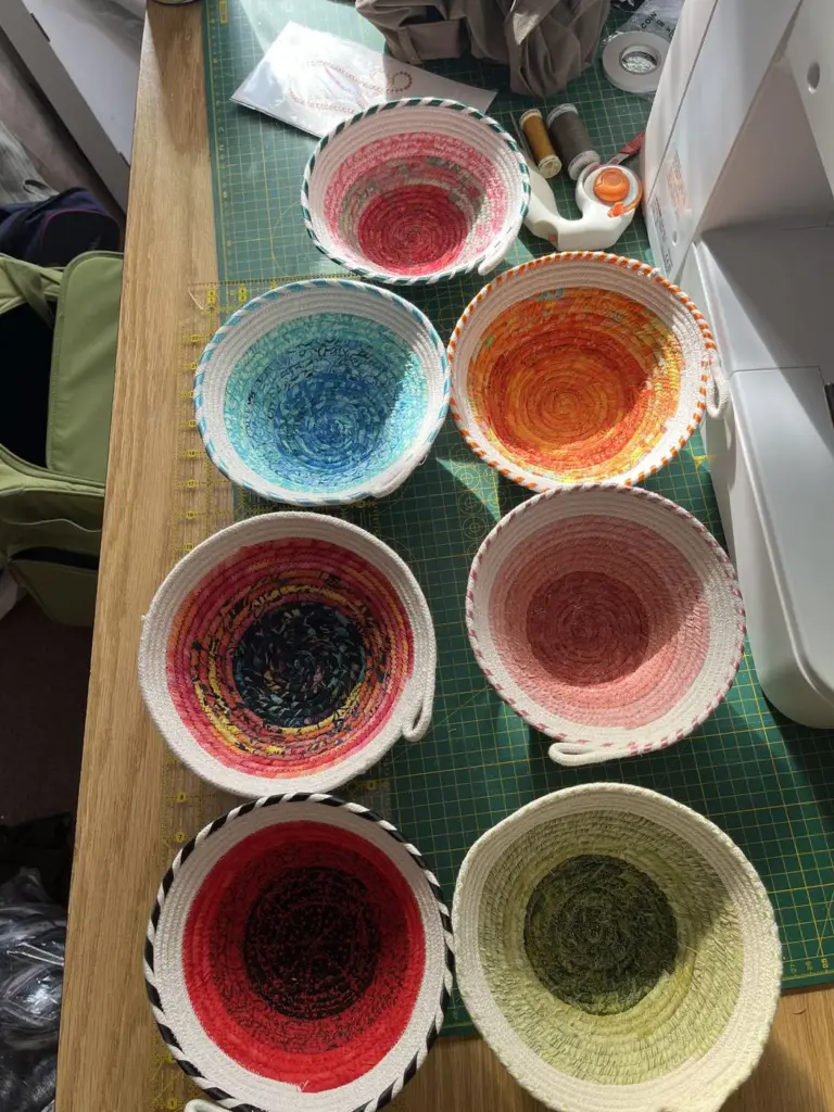 Six fabric-wrapped rope bowls in red, blue, orange and green