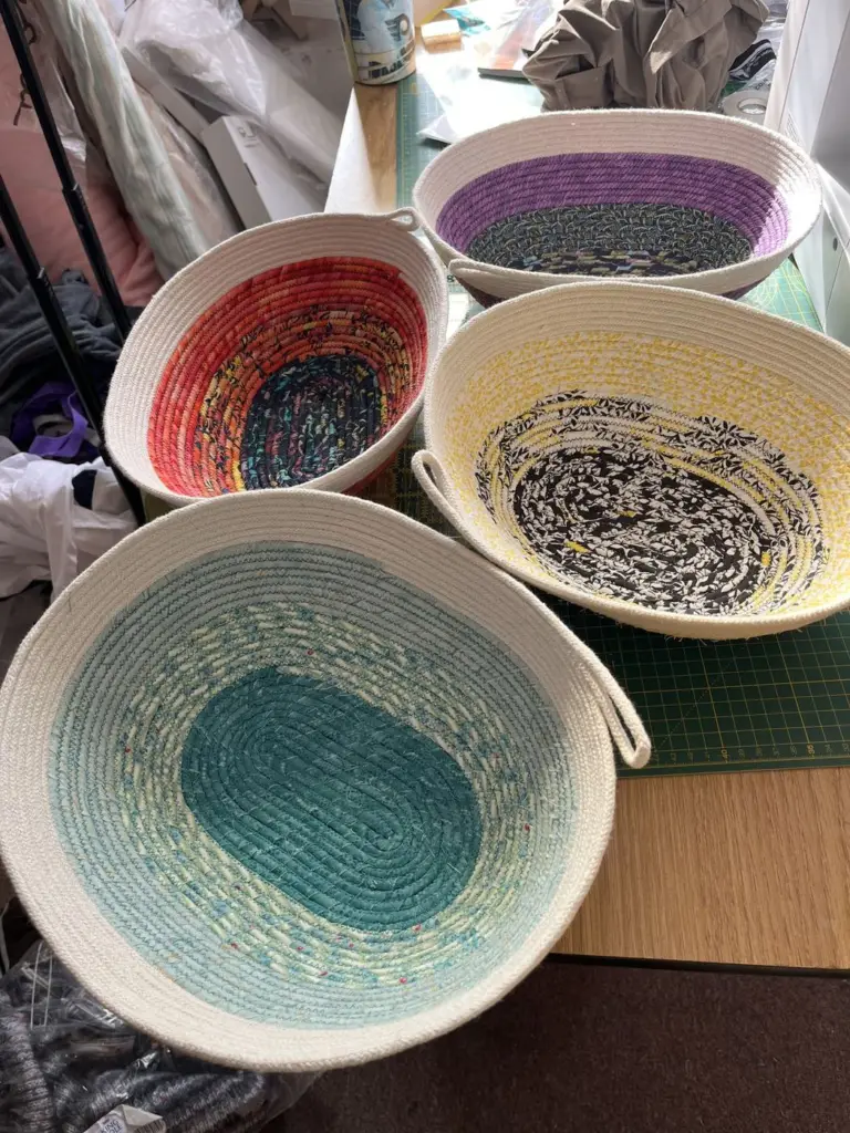 Three fabric rope bowls in turquoise, purple and black-and-white prints