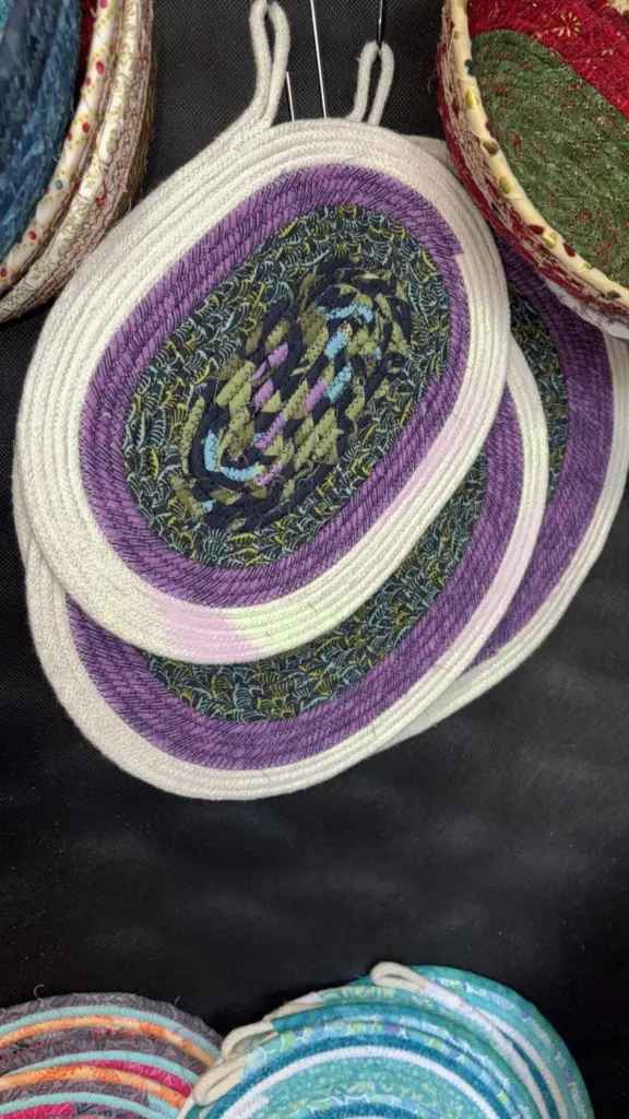 Oval fabric rope trivets in purple and green with hanging loops