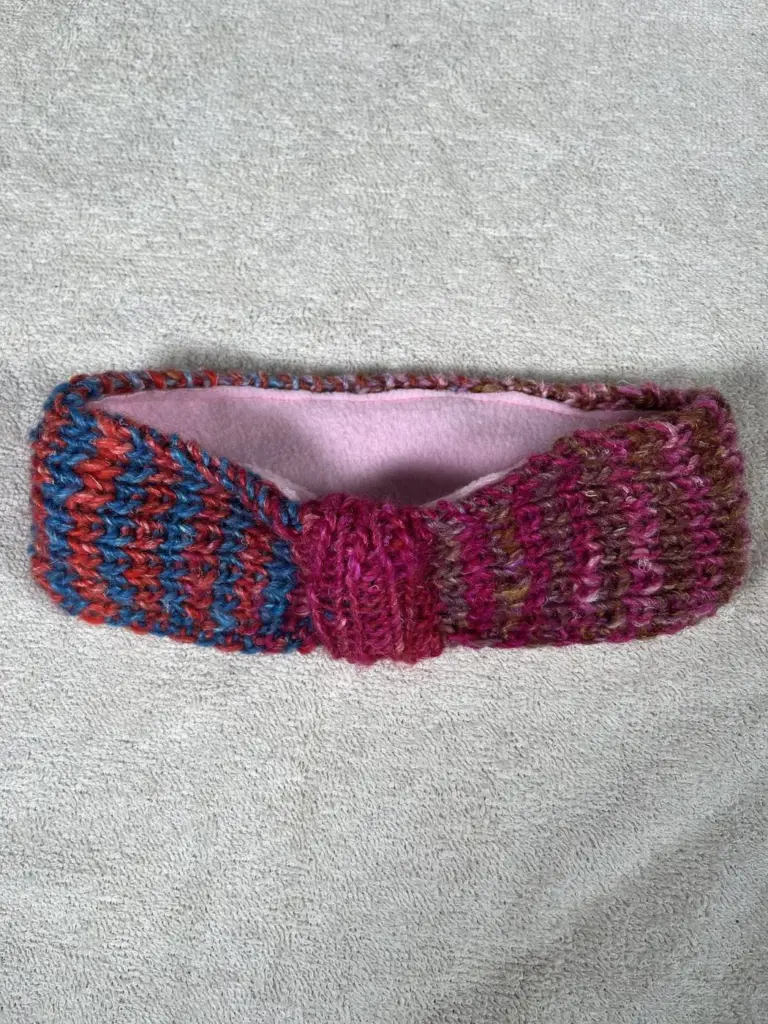 Hand knitted twisted headband in red and blue
