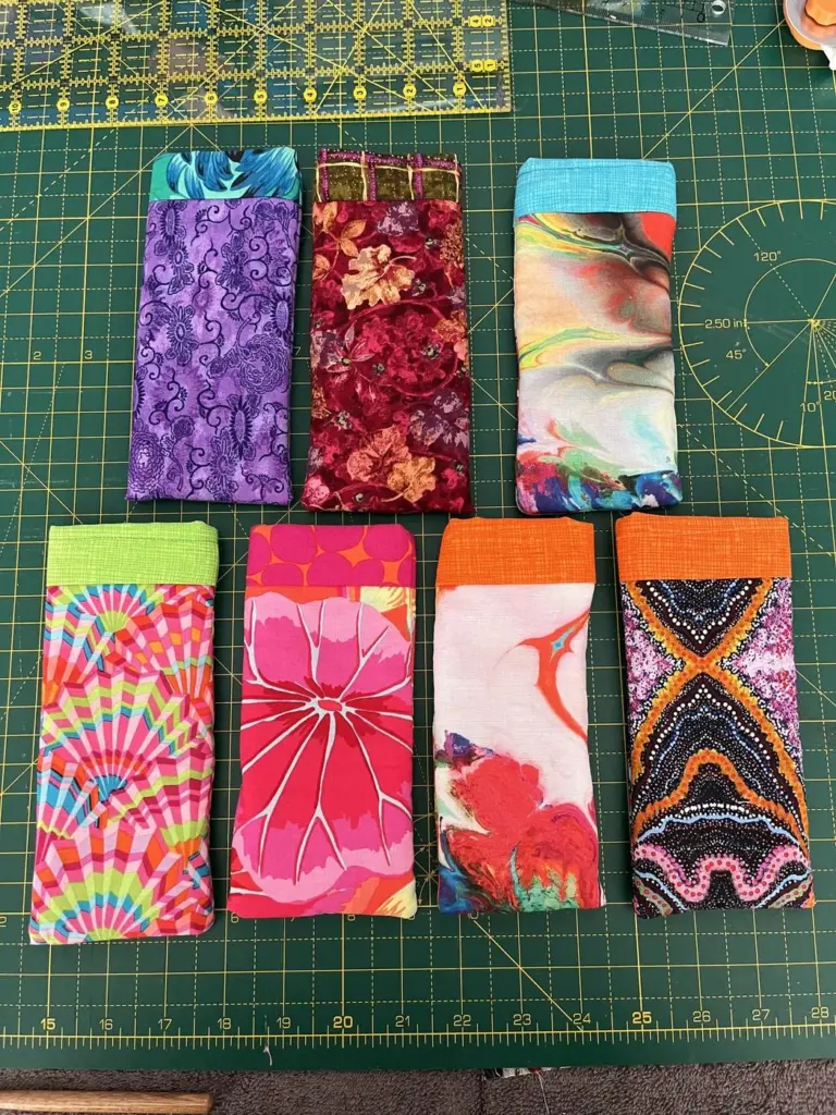 Eight sewn glasses cases in colourful prints